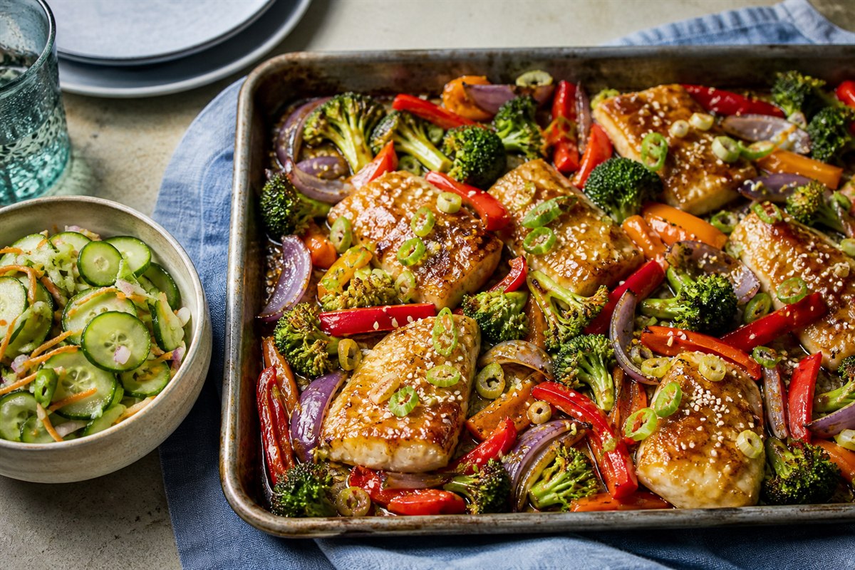 Ginger sweet and sour sauce fish sheet pan dinner with cucumber slaw lifestyle food photo